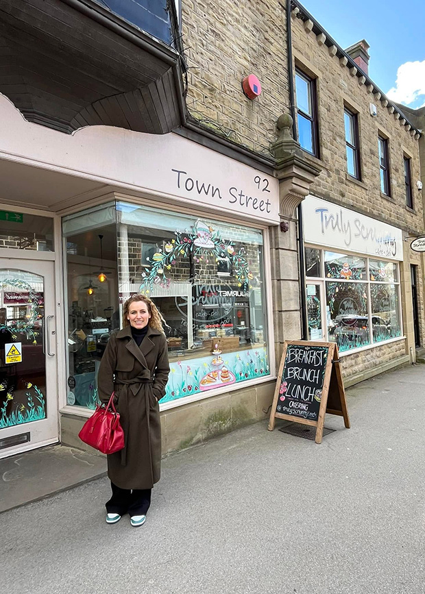 Katie in front of deli shop front
